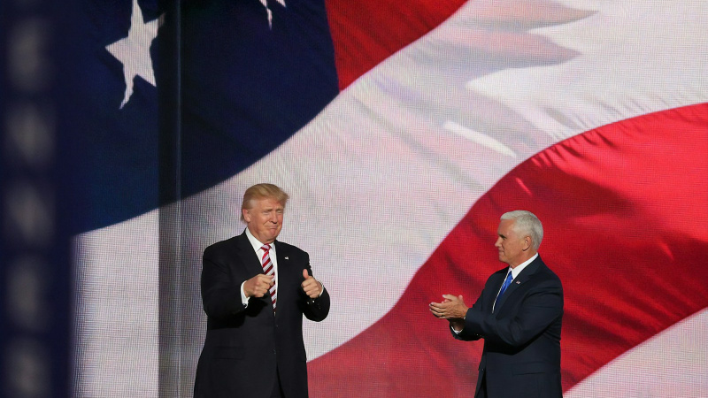 Donald Trump beside man in black suit